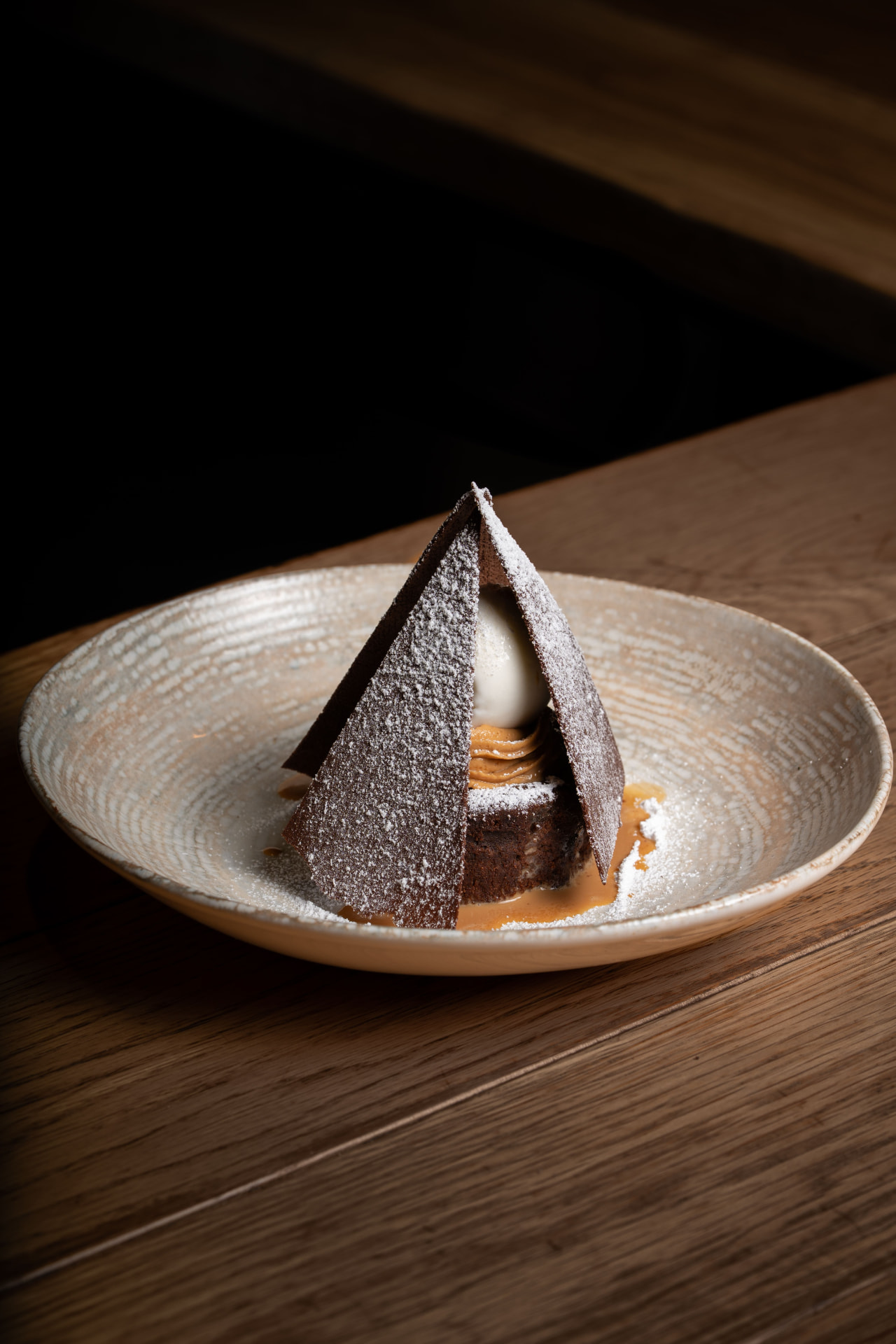 Chocolate dessert with tuiles, dulce de leche and ice cream