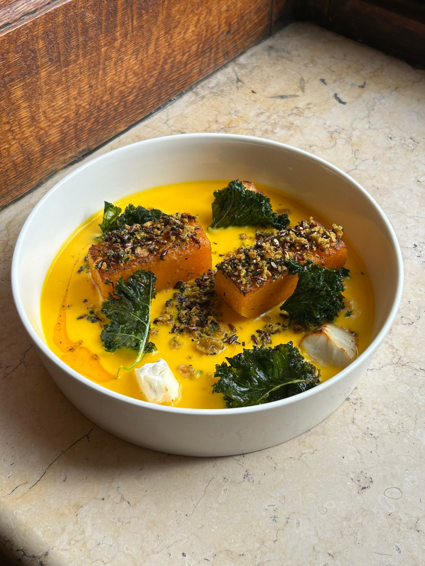 Roasted pumpkin in saffron cream with crisp kale