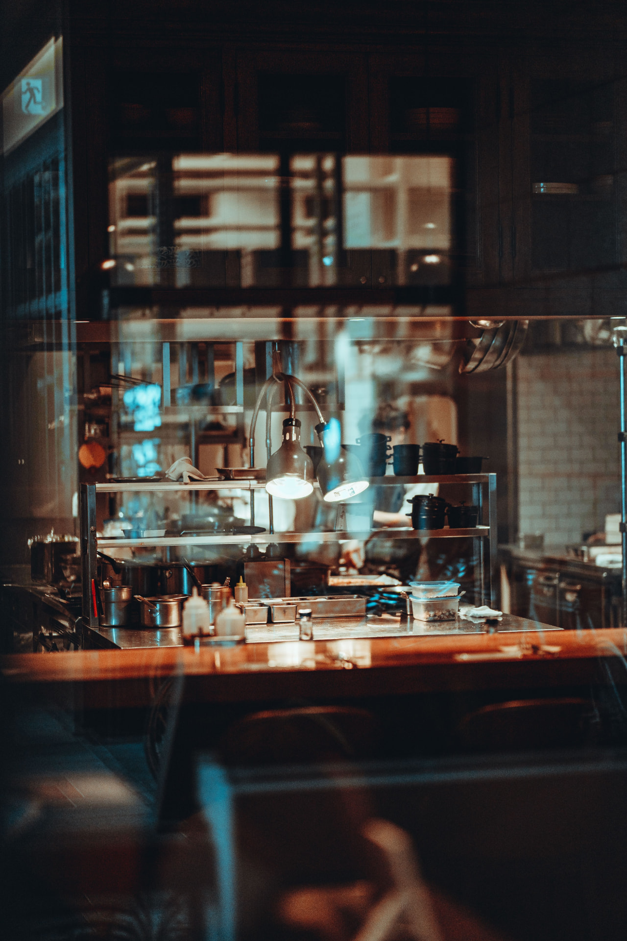 Professional kitchen with warm lighting and polished steel surfaces